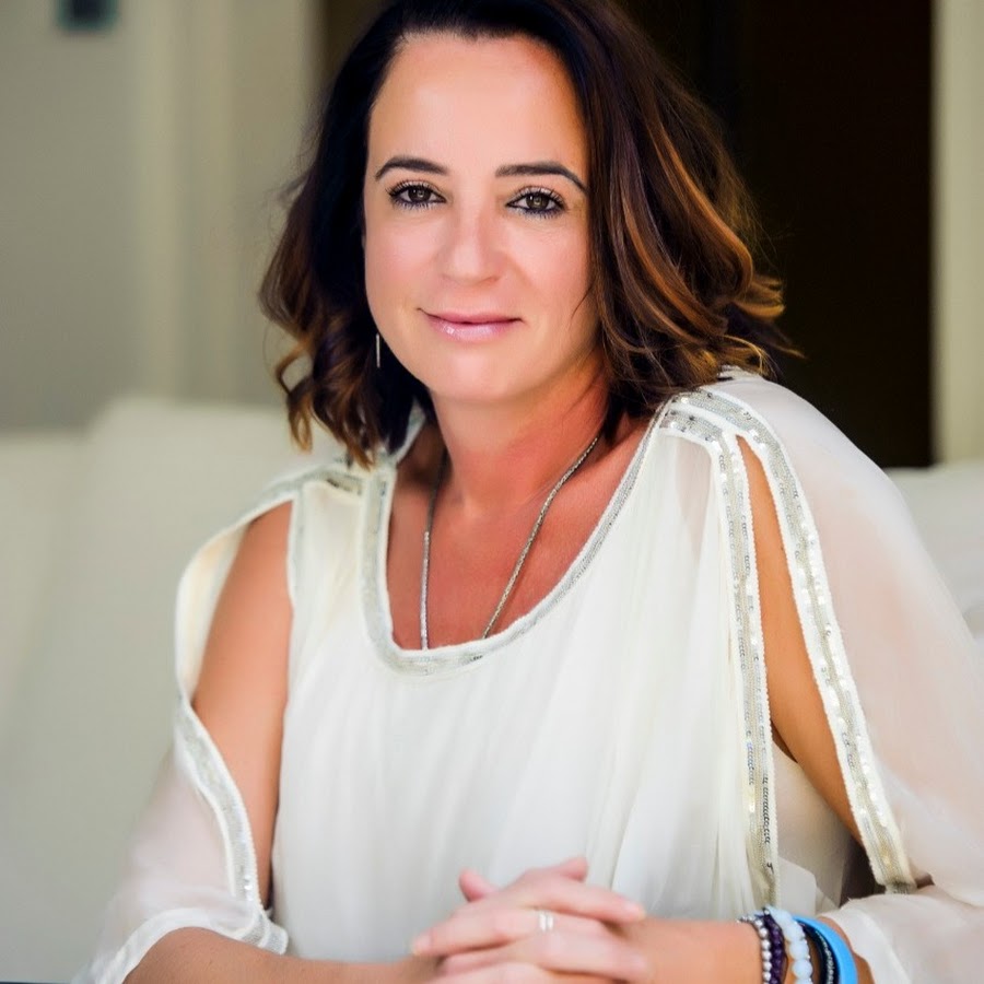 Justine Watson wearing a white dress along with colorful bengals 